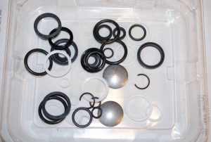 Photo showing parts inside the John Deere SCV Coupler Reseal or Overhaul kit for a JD 1640/2040 tractor.