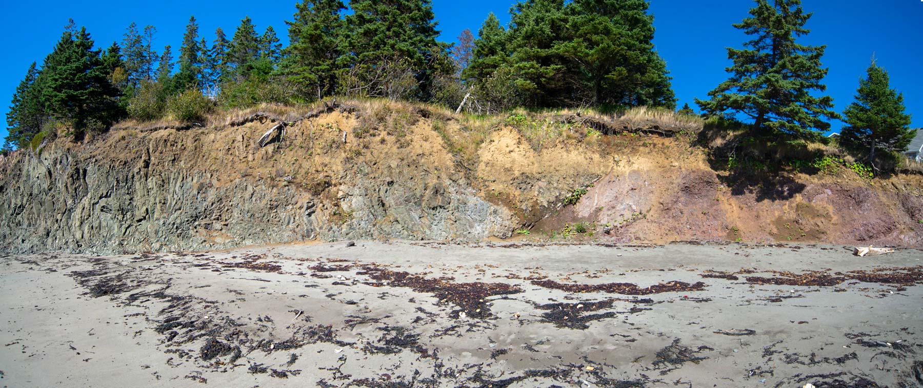 Image showing basalt type formations on the left meeting sedimentary formations on the right at Red Point beach on Grand Manan.