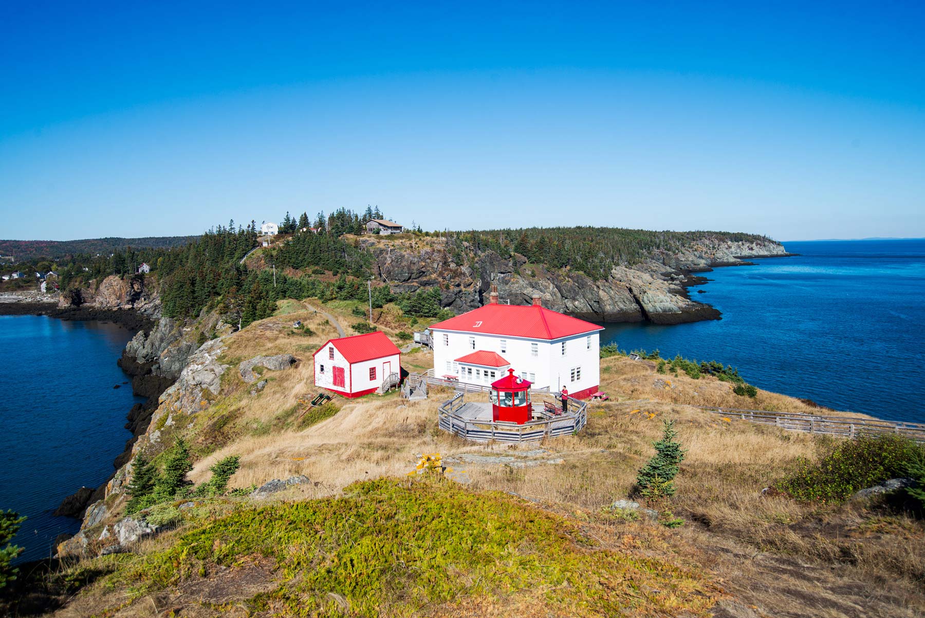 Image of the historic two story Light Keepers house and the one-and-one-half boat house on the Swallowtail peninsula at Grand Manan, NB.