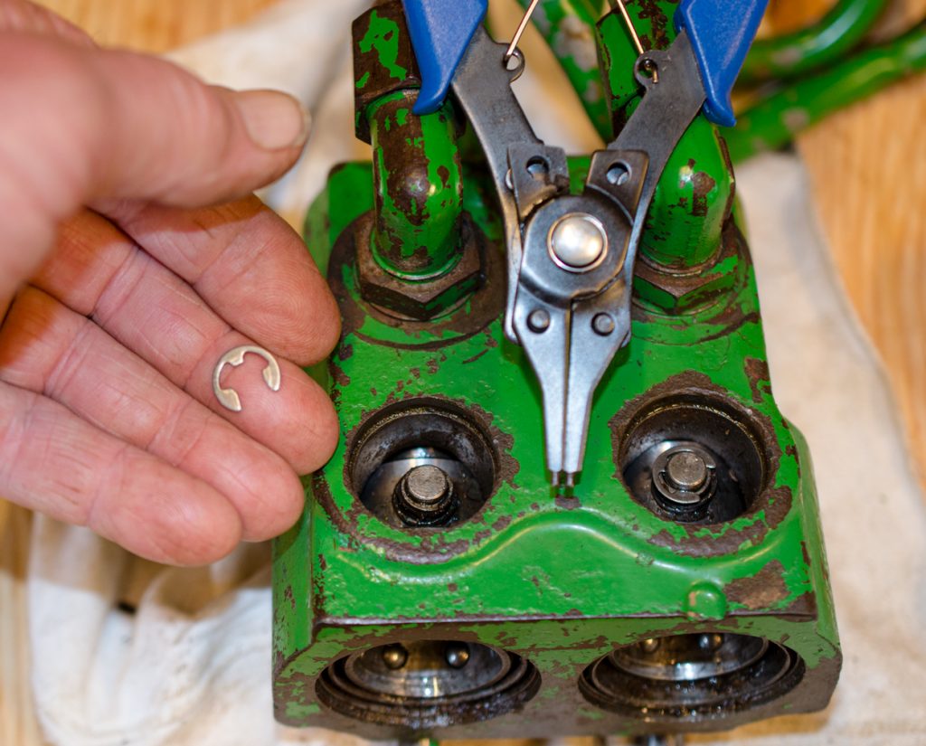 Photo showing removal of the C-clip on a John Deere 1640/2040 Breakaway Coupler.