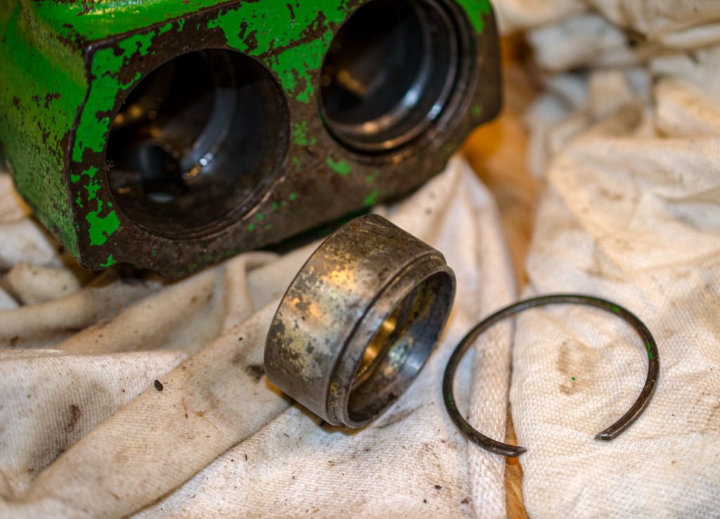 Photo showing the retaining snap ring and sleeve on a John Deere 1640/2040 Breakaway Coupler.