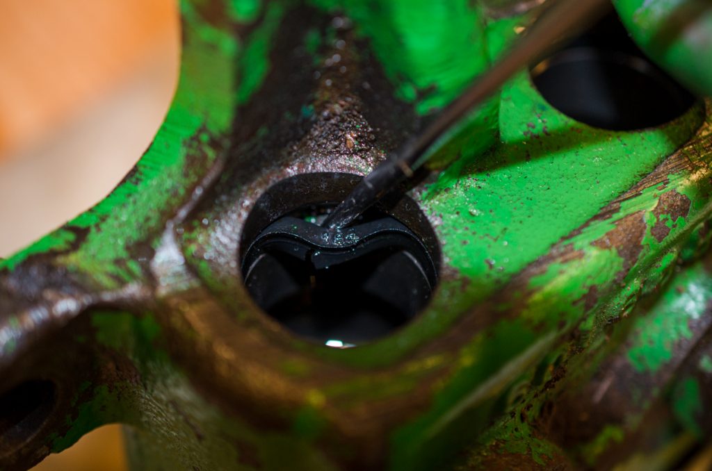 Photo showing removal of a V-Seal in housing on a John Deere 1640/2040 Breakaway Coupler.