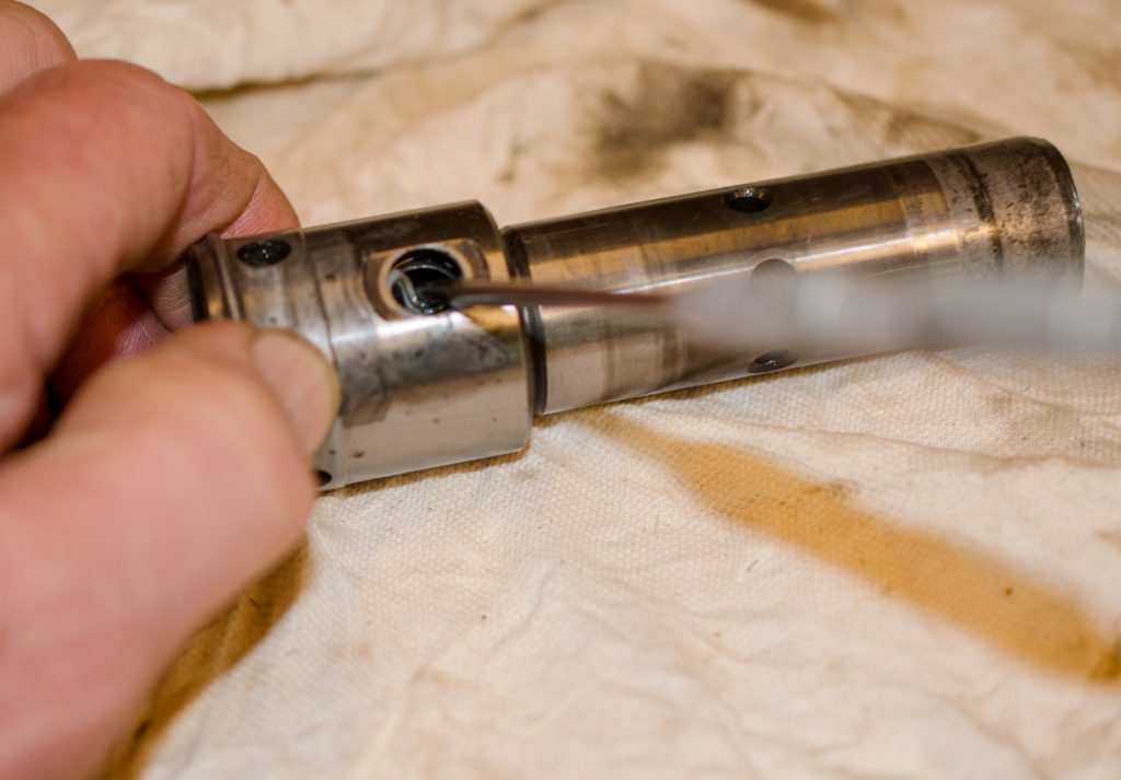 Photo showing removing the small O-ring and backup washer from the coupler of a John Deere 1640/2040 Breakaway Coupler.